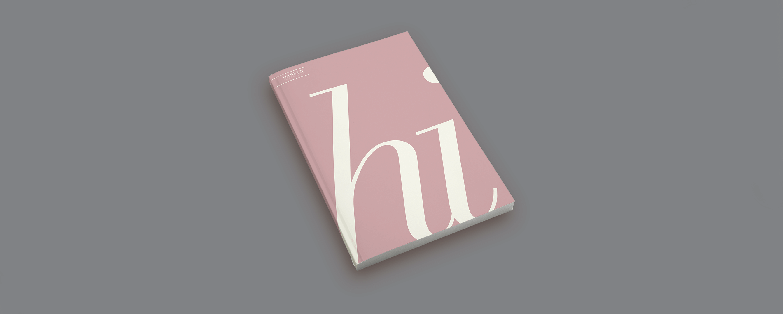 Brand Guide Line book with the initials of Harken Interiors coming off the page
